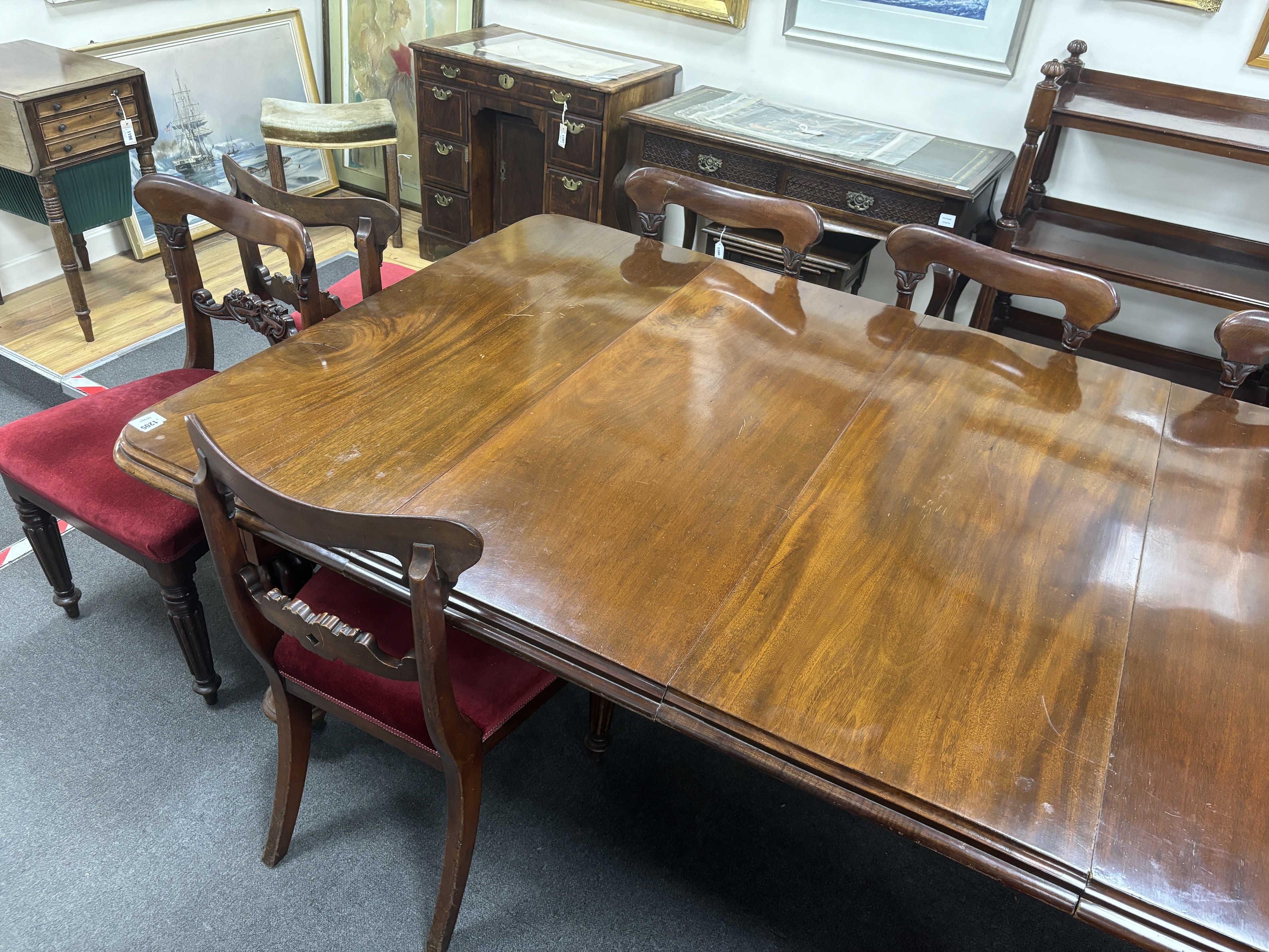 A Victorian mahogany extending dining table, 232cm extended, two spare leaves, depth 118cm, height 72cm together with a set of eight early Victorian mahogany dining chairs